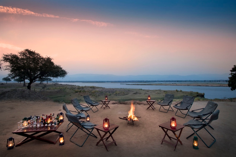 Zambezi-Expeditions-Mana-Pools-National-Park-Zimbabwe-Safari-Tented-Camp-African-Bush-Camps-around-fire-at-sunset-1-1-1
